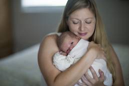 newborn and her mom in their home