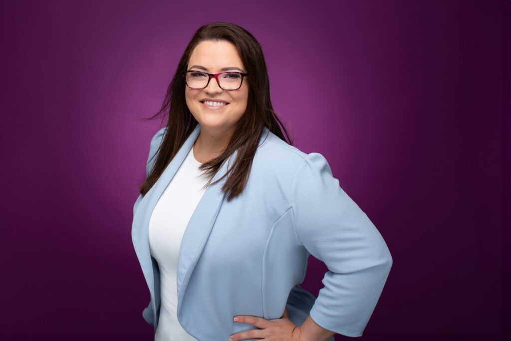 headshot of comedian on purple background